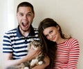 Happy couple at home with their cat