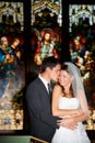 Happy couple, hug and kiss at wedding in church for marriage love or vow in commitment together. Married man or groom Royalty Free Stock Photo