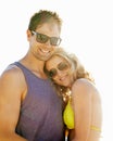 Happy, couple and hug on vacation by beach with sunglasses, smile and holiday for memories or honeymoon. Woman, man and Royalty Free Stock Photo