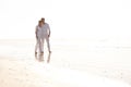 Happy couple, hug and walking with beach for love, embrace or valentines day in nature. Man and woman enjoying stroll by Royalty Free Stock Photo