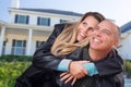 Happy Couple Hugging in Front of Beautiful House Royalty Free Stock Photo