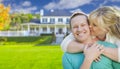 Happy Couple Hugging In Front of House Royalty Free Stock Photo