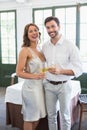 Happy couple hugging while holding wine glasses Royalty Free Stock Photo