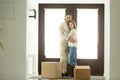 Happy couple hugging looking at camera moving into new home Royalty Free Stock Photo