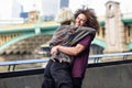 Happy couple hugging near the Southwark bridge over River Thames, London Royalty Free Stock Photo