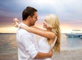 Happy couple hugging over sunset beach background Royalty Free Stock Photo