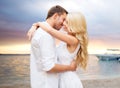 Happy couple hugging over sunset at summer beach Royalty Free Stock Photo