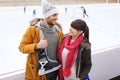 Happy couple with ice-skates on skating rink Royalty Free Stock Photo