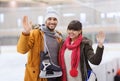 Happy couple with ice-skates on skating rink Royalty Free Stock Photo