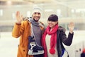 Happy couple with ice-skates on skating rink Royalty Free Stock Photo