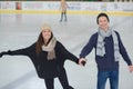 Happy couple ice skating outdoors Royalty Free Stock Photo