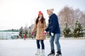 Happy couple ice skating on rink outdoors Royalty Free Stock Photo