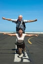 Happy couple imitating airplane at the airport