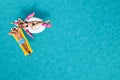 Couple with inflatable ring and mattress in swimming pool, top view. Summer vacation Royalty Free Stock Photo