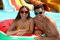 Couple with inflatable ring at water park. Summer vacation