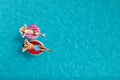 Couple with inflatable rings in swimming pool, top view and space for text. Summer vacation Royalty Free Stock Photo