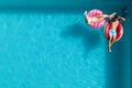 Couple with inflatable rings in swimming pool, top view and space for text. Summer vacation Royalty Free Stock Photo