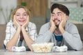 happy couple with joypads and popcorn