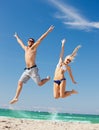 happy couple jumping on the beach Royalty Free Stock Photo