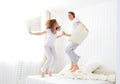 Happy couple jumping and having fun in bed Royalty Free Stock Photo