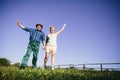 Happy couple jumping and waving. Royalty Free Stock Photo