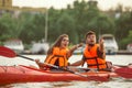 Happy couple kayaking on river with sunset on the background Royalty Free Stock Photo