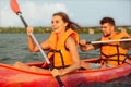 Happy couple kayaking on river with sunset on the background Royalty Free Stock Photo