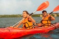 Happy couple kayaking on river with sunset on the background Royalty Free Stock Photo