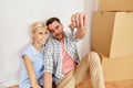 Happy couple with key and boxes moving to new home Royalty Free Stock Photo