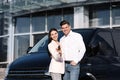 Happy couple with key near car on street. Buying new auto Royalty Free Stock Photo