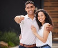 Happy couple with key to new home together, buying property as married man and woman and moving into real estate house Royalty Free Stock Photo