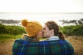 Happy couple, kiss and bonding together in nature, blanket and romantic getaway with camping by ocean. Man, woman or Royalty Free Stock Photo