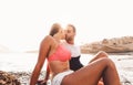 Happy couple kissing on the beach at sunset - Young lovers having romantic tender moments on summer time Royalty Free Stock Photo