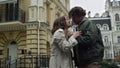 Happy couple kissing on city background. Man and woman running along street. Royalty Free Stock Photo