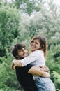 Happy couple kissing and hugging in nature. Young man and woman in loving relationship having fun in park Royalty Free Stock Photo