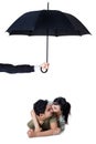 Happy couple kissing in studio under umbrella Royalty Free Stock Photo