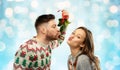 Happy couple kissing under mistletoe on christmas