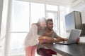Happy Couple On Kitchen Using Laptop Computer Modern Apartment With Panoramic Window Royalty Free Stock Photo