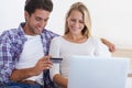 Happy couple, laptop and credit card for ecommerce, payment or banking together in relax at home. Man and woman smile Royalty Free Stock Photo