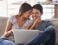 Happy couple, laptop and love on sofa with good news, support or care in living room at home. Excited man or woman with Royalty Free Stock Photo