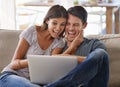 Happy couple, laptop and sofa with good news for winning, giveaway or surprise in living room at home. Excited man and Royalty Free Stock Photo