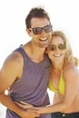 Happy, couple and laugh on vacation by beach with sunglasses, hug and holiday for memories or honeymoon. Woman, man and Royalty Free Stock Photo