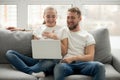 Happy couple laughing with joy looking at laptop at home Royalty Free Stock Photo