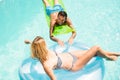 Happy couple with lilos in the pool Royalty Free Stock Photo