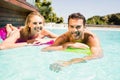 Happy couple with lilos in the pool Royalty Free Stock Photo
