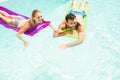 Happy couple with lilos in the pool Royalty Free Stock Photo