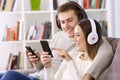 Happy couple listening to music on line at home Royalty Free Stock Photo