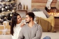 Happy couple in living room decorated for Christmas