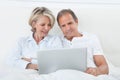 Happy couple looking at digital tablet Royalty Free Stock Photo