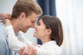 Happy couple looking at each other with love. Close up shot of sweet joyful man and woman touching each other`s noses at Royalty Free Stock Photo